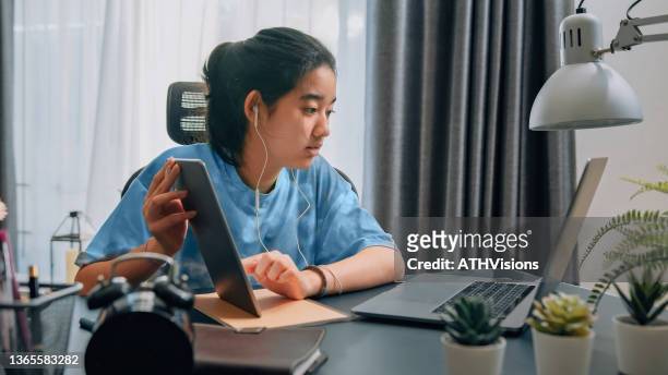 teenager girl watching online learning class on a laptop computer. homeschooling video call with teacher . - very young webcam girls stockfoto's en -beelden