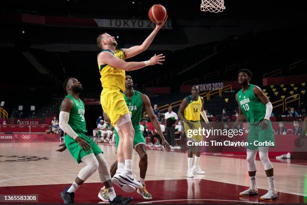 Joe Ingles of Australia drives to the basket watched by Ekpe Udoh of Nigeria during the Australia V Nigeria basketball preliminary round match at the...