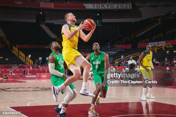 Joe Ingles of Australia drives to the basket watched by Ekpe Udoh of Nigeria during the Australia V Nigeria basketball preliminary round match at the...