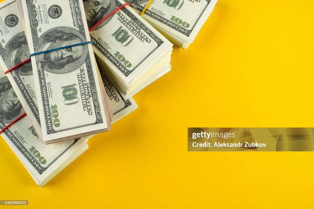 A banknote in US dollars in bundles On a bright background. The concept of finance and economics, investments. Salary, bribe, profit or credit funds. Space for copying.