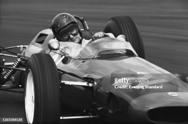 British racing driver Mike Hailwood in a Reg Parnell Racing Lotus 25-BRM at the 1964 BRDC Daily Express International Trophy Race at Silverstone, UK,...