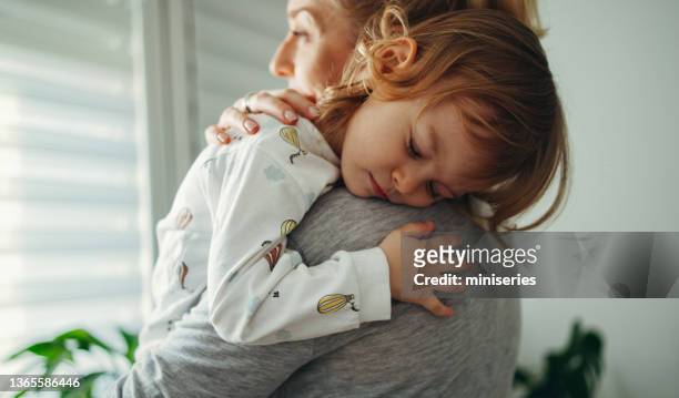 Portrait of a Mother Holding her Sleepy Daughter in the Morning