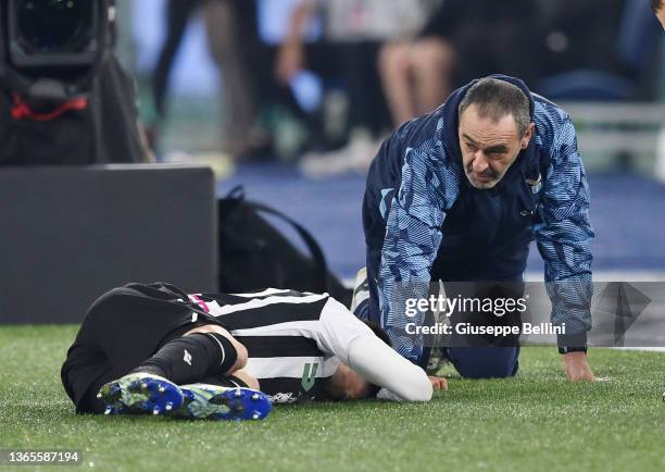 Maurizio Sarri head coach of SS Lazio falls to the ground after a clash with Ignacio Pussetto of Udinese Calcio during the Coppa Italia match between...