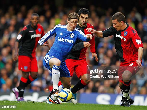 Fernando Torres of Chelsea takes on Ricardo Rocha and Jason Pearce of Portmouth during the FA Cup sponsored by Budweiser Third Round match between...