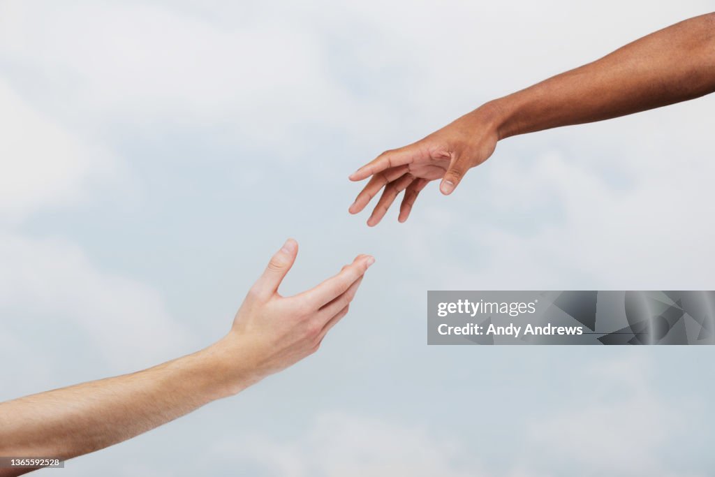 Two men reaching out to each other