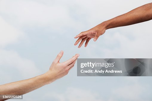 Two men reaching out to each other Two men reaching out to each other