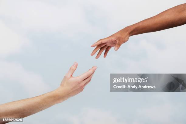 two men reaching out to each other - hand stock pictures, royalty-free photos & images