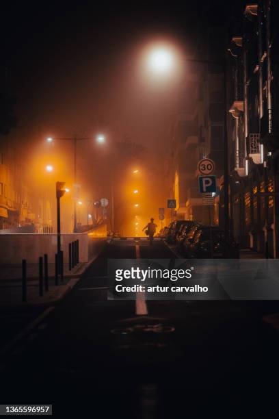 foggy street light in night in lisbon - dark alley stock pictures, royalty-free photos & images