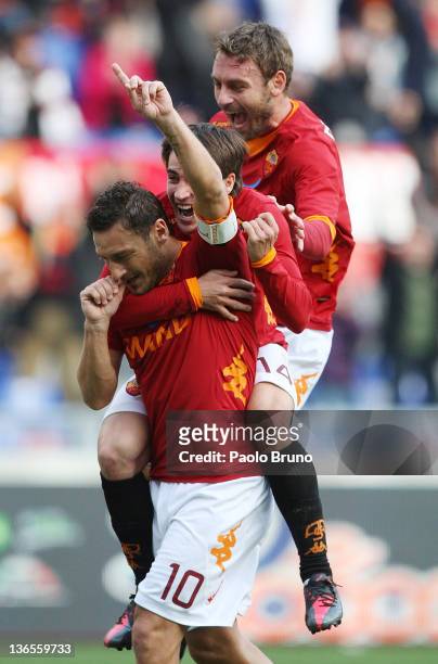Francesco Totti of AS Roma celebrates with team-mates Bojan Krkic and Daniele De Rossi after scoring a goal from the penalty spot during the Serie A...