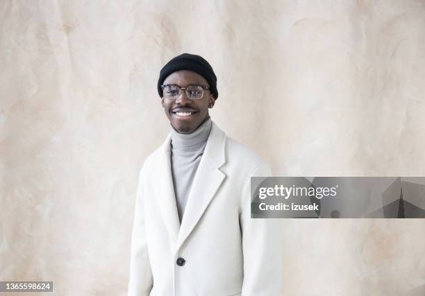 elegant young man wearing white coat - vit jacka bildbanksfoton och bilder