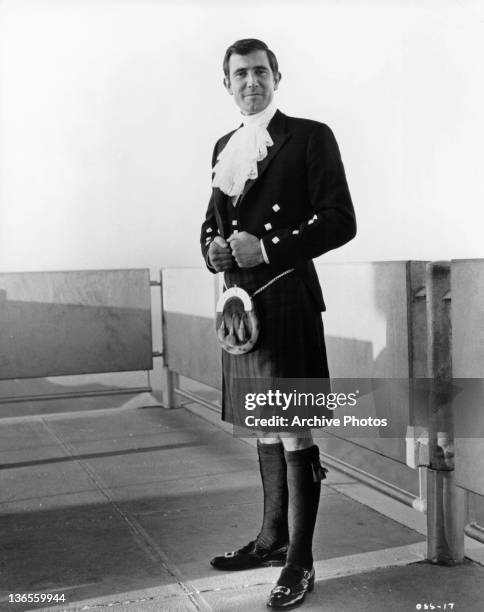 George Lazenby disguised as Sir Hilary Bray, the genealogical expert assigned to help Spectre Chief Blofeld in a scene from the film 'On Her...