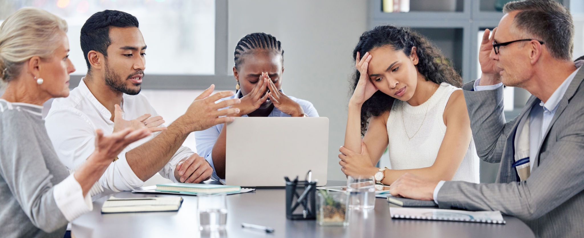 Shot of a group of businesspeople looking stressed out while working together in an office Shot of a group of businesspeople looking stressed out while working together in an office