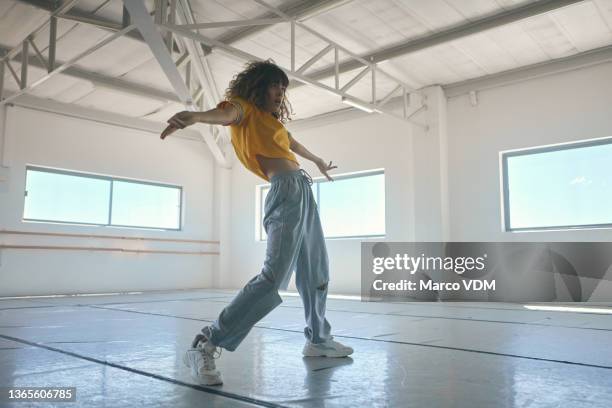 full length shot of an attractive young female hip hop dancer practicing in her studio - hip hop dance stock pictures, royalty-free photos & images