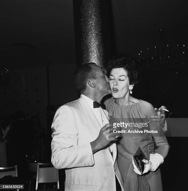 Producer Robert Cohn and American actress Rosalind Russell at a Hollywood Foreign Press Association Annual Installation, USA, 1964.