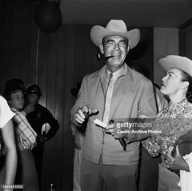 American actor Fred MacMurray and his wife, actress June Haver at a SHARE Boomtown benefit party, USA, 1965.