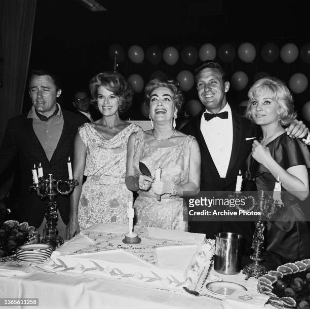 From left to right, actors Robert Vaughn, Janis Paige, Joan Crawford, Robert Stack and Susan Oliver at a party thrown by the production company for...