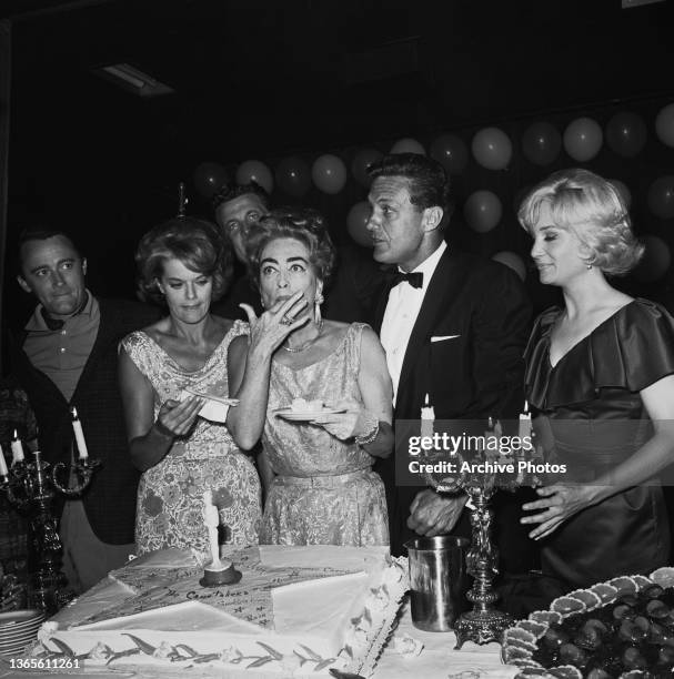 From left to right, actors Robert Vaughn, Janis Paige, Joan Crawford, Robert Stack and Susan Oliver at a party thrown by the production company for...