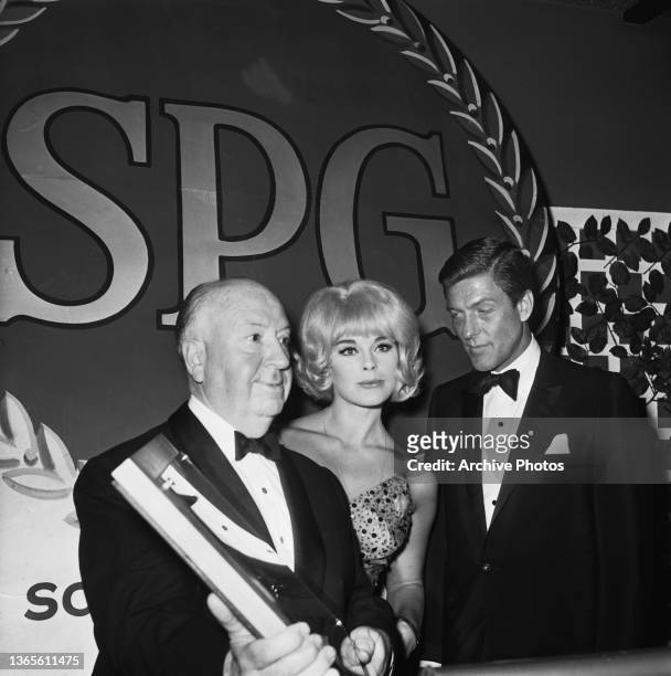 English filmmaker Alfred Hitchcock accepts the Milestone Award from the Screen Producers Guild at an awards ceremony, USA, 7th March 1965. Actors...