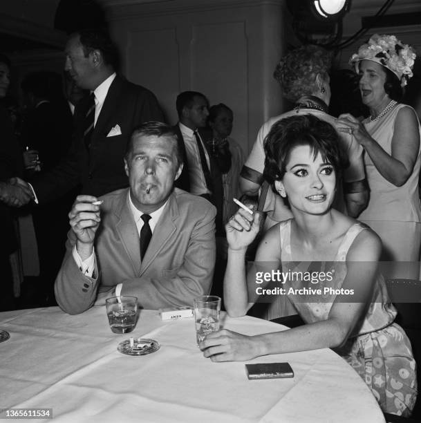 American actor George Peppard and his partner, actress Elizabeth Ashley at a party for the film 'Ship of Fools', USA, 1965. Ashley stars in the film.