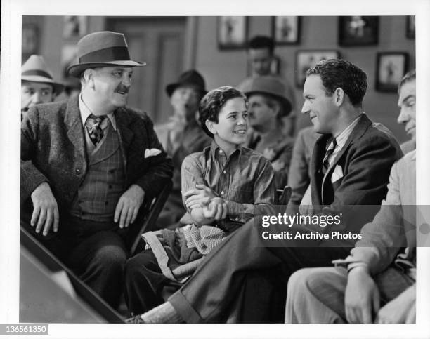 Frank Morgan watches as Gene Reynolds talks to prize fighter William Gargan in a scene from the film 'The Crowd Roars', 1938.