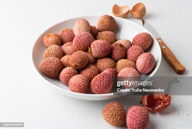 lychee fruit on a light background. - lychee stock pictures, royalty-free photos & images