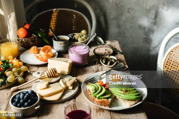variety of healthy food on breakfast table - brunch stock pictures, royalty-free photos & images