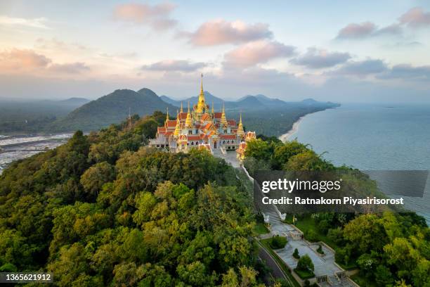 aerial drone sunset scene of pagodas at pramahatart chedi pakdepragard, wat tang sai temple, ban krut, bang saphan, prachuap khirikhan, thailand - thailand stockfoto's en -beelden