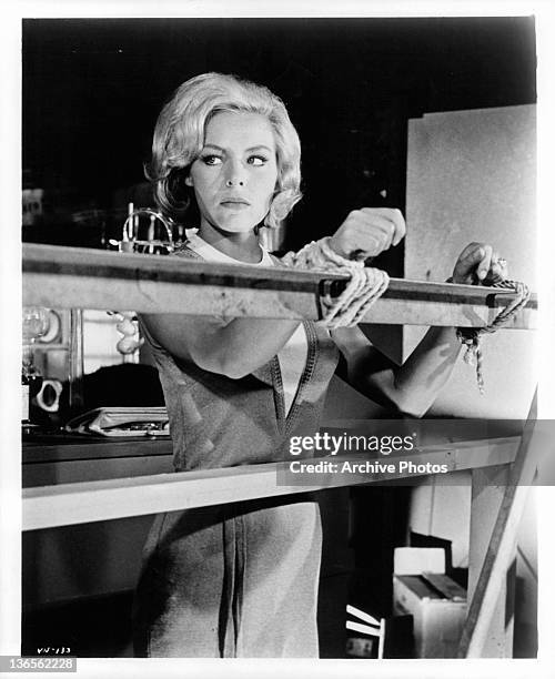 Janine Gray tied to rail in a scene from The Deadly Games Affair episode from the television series 'The Man From U.N.C.L.E.', 1964.