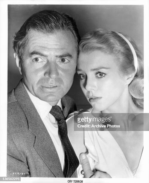 James Mason and Inger Stevens hold each other in a scene from the film 'Cry Terror!', 1958.