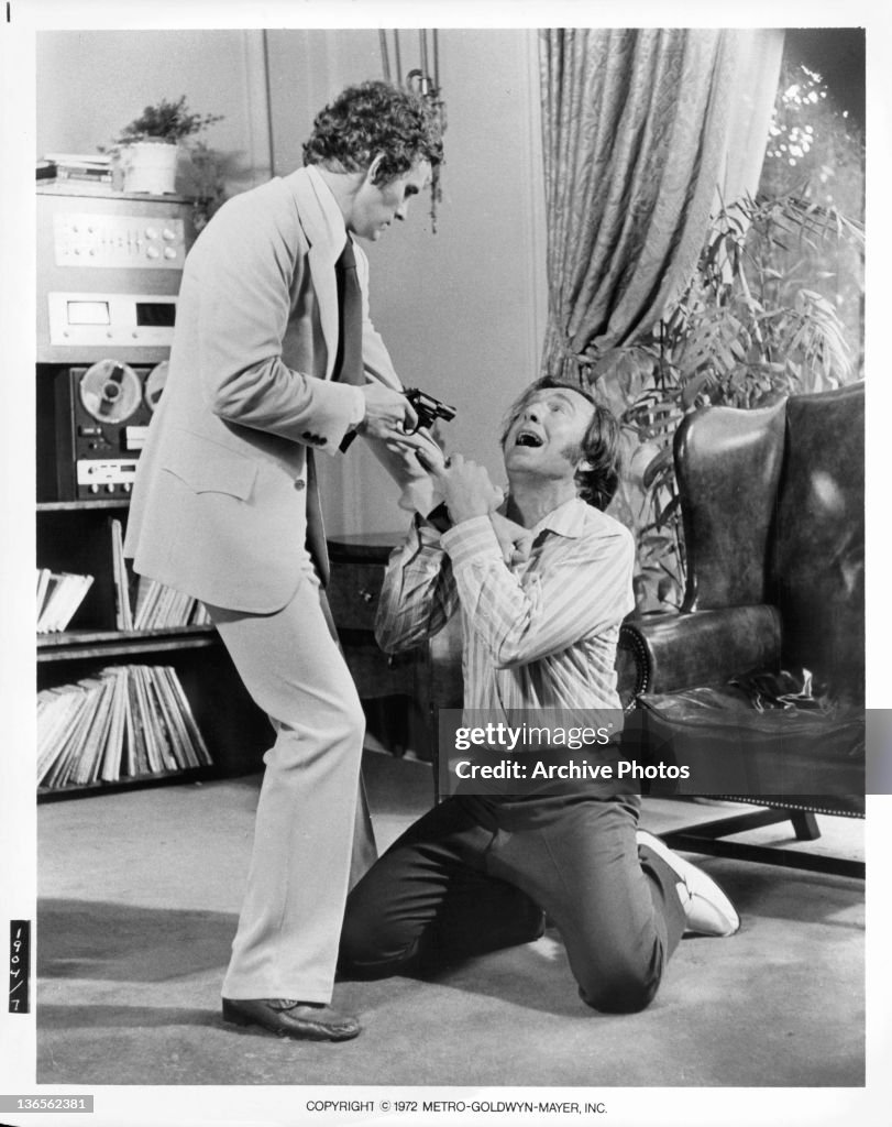 Dark Rambo Dack Rambo pointing gun at unidentified man in a scene from the film ...