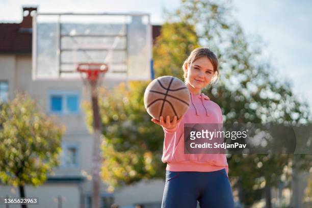 active caucasian teenage girl, holding the basketball ball - basket sport stock pictures, royalty-free photos & images