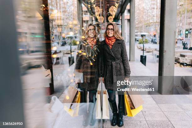 woman doing window shopping in city - madrid shopping stock pictures, royalty-free photos & images