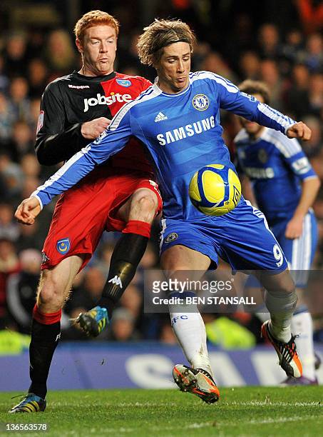 Chelsea's Spanish striker Fernando Torres vies for the ball with Portsmouth's English striker Dave Kitson during the English FA Cup third round...