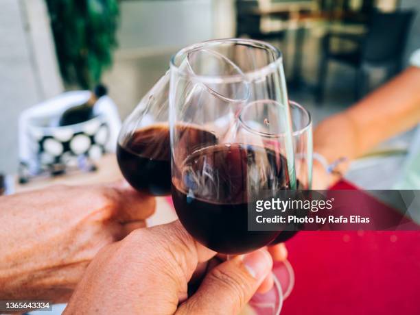 three wine glasses in a celebration toast - sweet wine stock-fotos und bilder