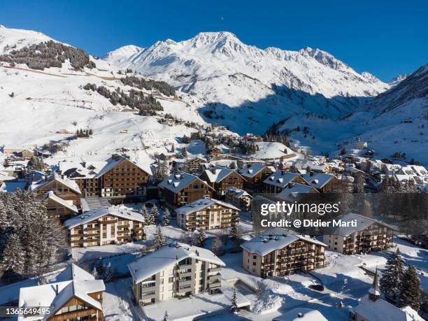 aerial view of the andermatt village on a sunny winter day in switzerland - chalet mountain foto e immagini stock