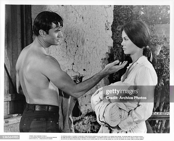 George Maharis reaches out to touch the chin Katy Jurado in a scene from the film 'A Covenant With Death', 1967.