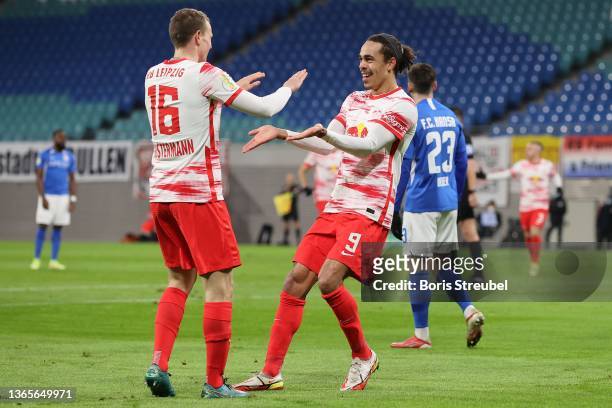 Yussuf Poulsen of Leipzig celebrates scoring the opening goal with team mate Lukas Klostermann during the DFB Cup round of sixteen match between RB...