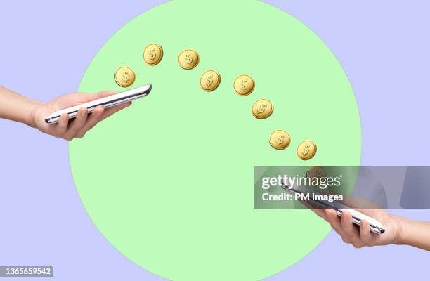 exchanging money via smart phones - paying with money stockfoto's en -beelden