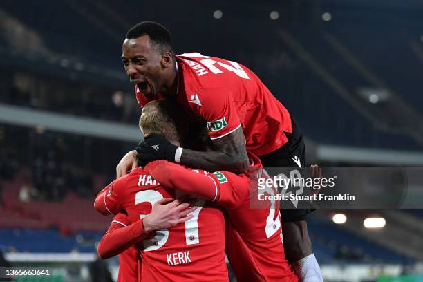 Gael Bella Ondoua of Hannover celebrates the 3rd team goal with his team mates during the DFB Cup round of sixteen match between Hannover 96 and...
