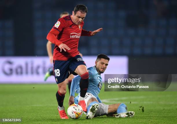 Kike of Osasuna is challenged by Okay Yokuslu of Celta Vigo during the LaLiga Santander match between RC Celta de Vigo and CA Osasuna at...