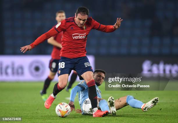 Kike of Osasuna is challenged by Okay Yokuslu of Celta Vigo during the LaLiga Santander match between RC Celta de Vigo and CA Osasuna at...