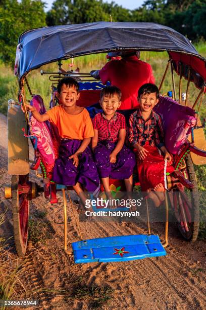 burmese little children sitting on a horse cart, bagan, myanmar - myanmar culture stockfoto's en -beelden