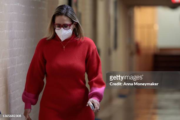 Sen. Kyrsten Sinema walks to her office in the basement of the U.S. Capitol Building on January 19, 2022 in Washington, DC. Later tonight, the Senate...
