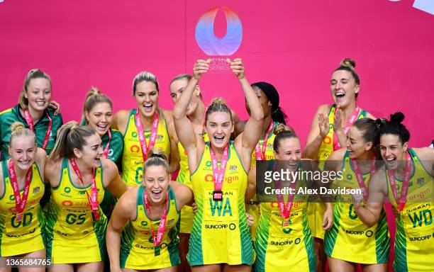 Liz Watson of Australia lifts the Vitality Series Trophy with teammates after victory in the 2022 Netball Quad Series match between Vitality Roses...