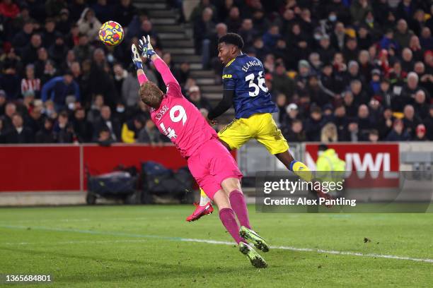 Anthony Elanga of Manchester United scores their side's first goal past Jonas Loessl of Brentford during the Premier League match between Brentford...