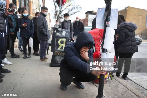 Friends and classmates visit a memorial for 15-year-old Caleb Westbrooks in the West Town neighborhood on January 19, 2022 in Chicago, Illinois....