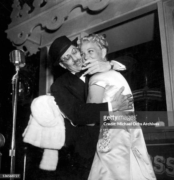 American comedian Groucho Marx embracing actress Betty Hutton , circa 1956.
