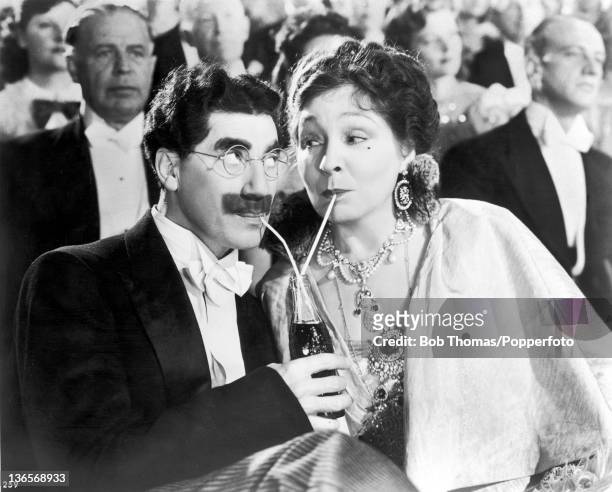 Groucho Marx and Margaret Dumont in a scene from the Marx Brothers comedy 'A Night At The Opera', directed by Sam Wood, 1935.