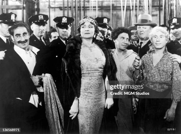 Scene from the Marx Brothers comedy 'A Night At The Opera', directed by Sam Wood, 1935. Left to right: Groucho Marx , Margaret Dumont , Chico Marx...