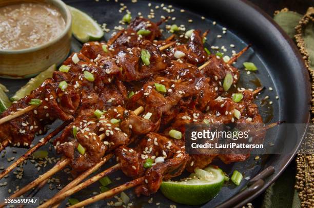 grilled teriyaki pork satay with a sesame dipping sauce - skewer stock pictures, royalty-free photos & images